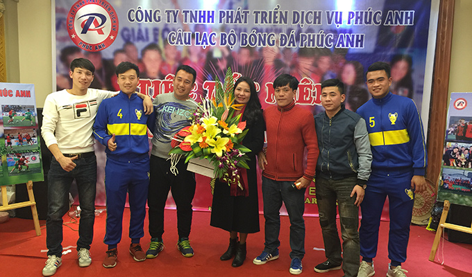 Phó TGĐ Vietfootball Dương Thanh Liêm và cầu thủ Cường Quốc tặng hoa chúc mừng FC Phúc Anh. Ảnh TP